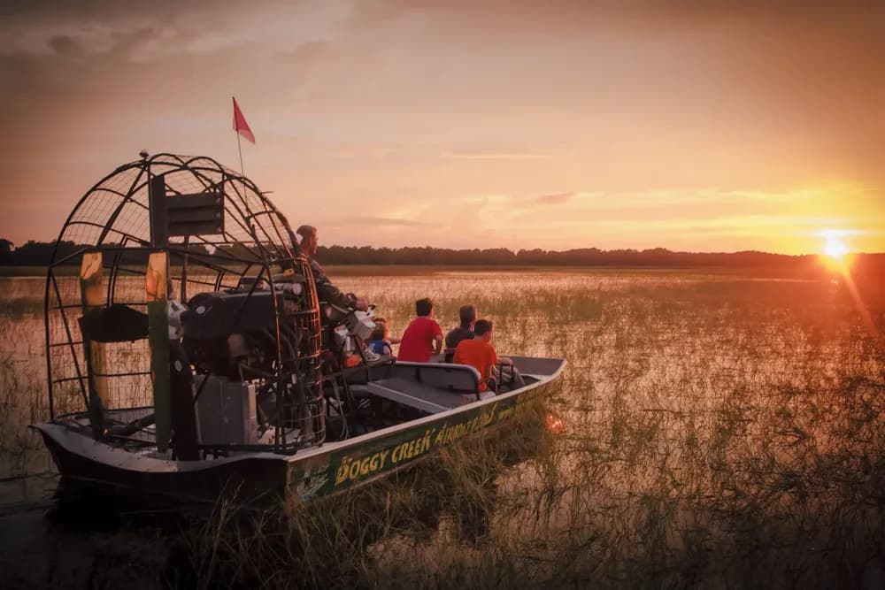 Airboat at sunset over the marsh